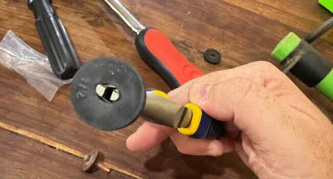 Needle-nose pliers loosening a washer